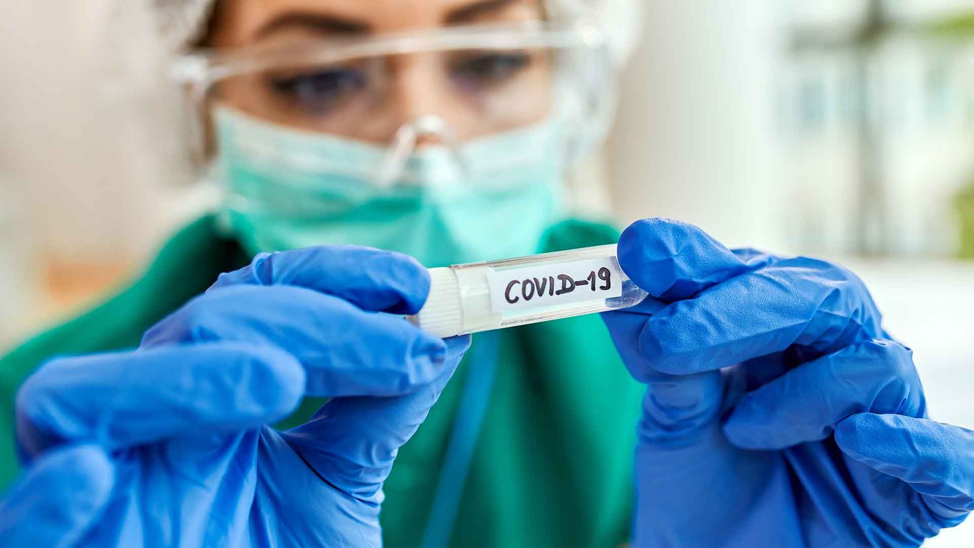 Médico con cartel COVID
